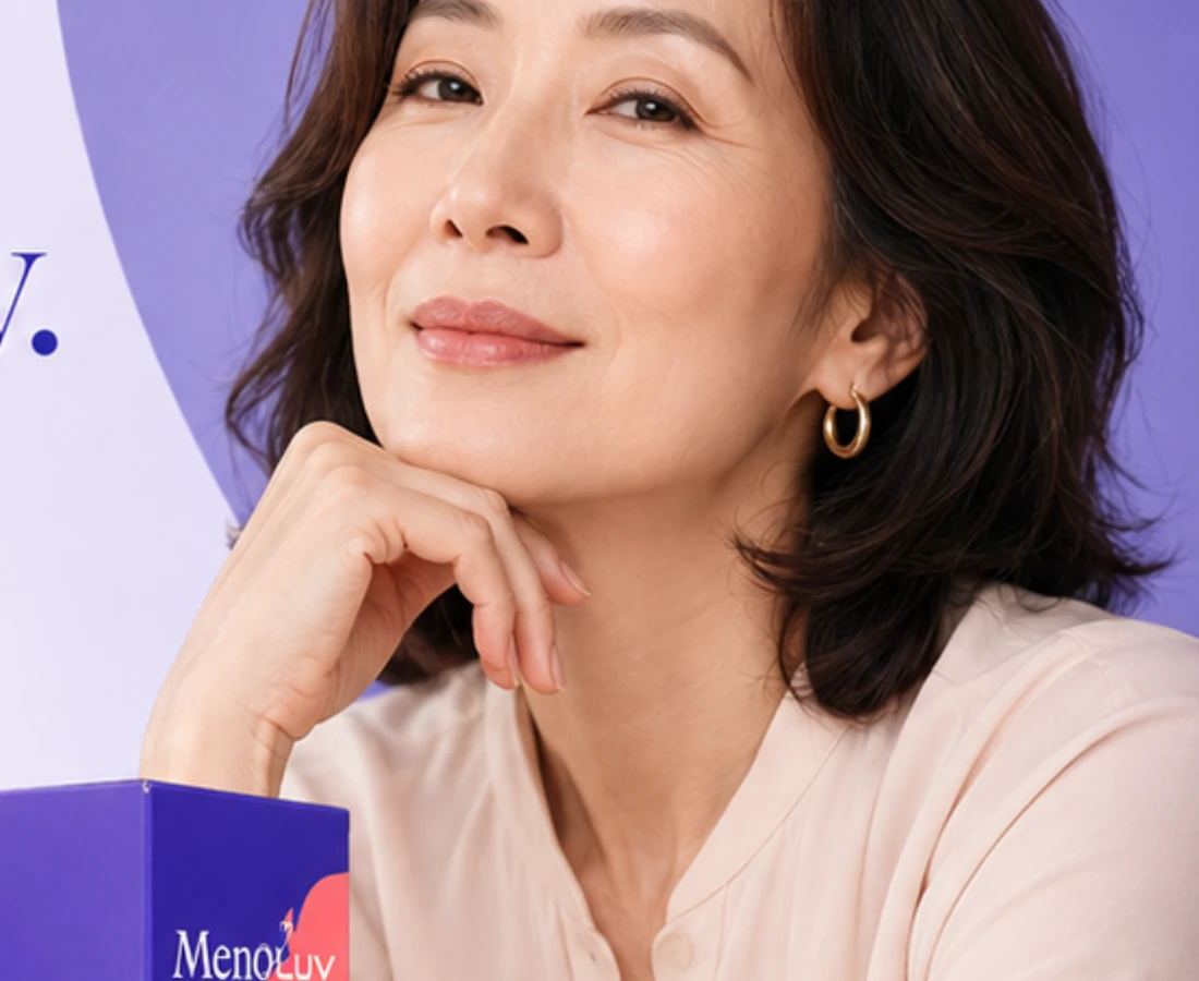 Woman in her fifties resting her chin on her hand, smiling calmly beside a MenoLuv box